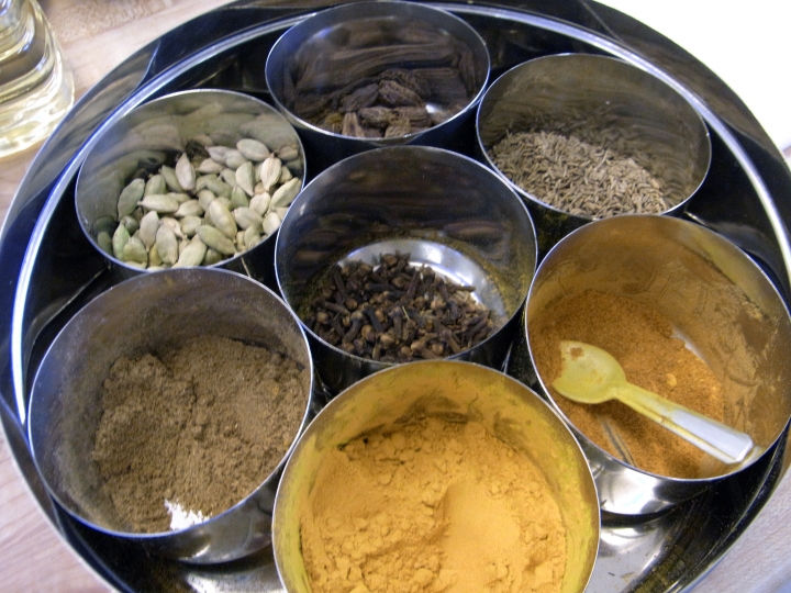 Typical Indian spice box with severarl spices in their containers.