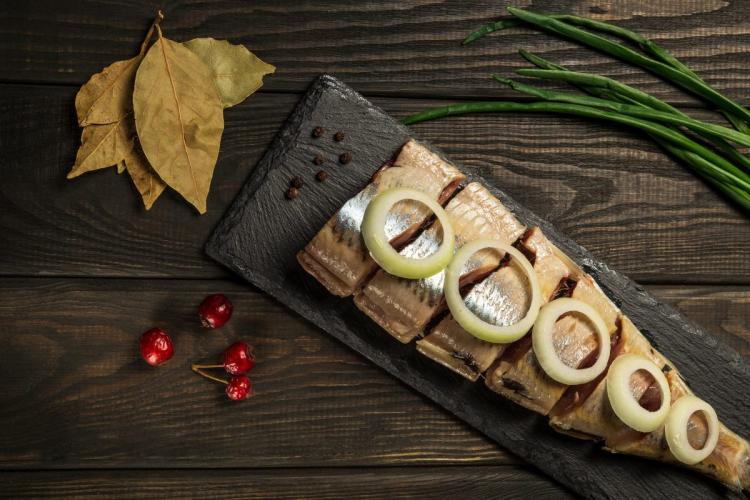 Dutch raw herring served with onion and spices.