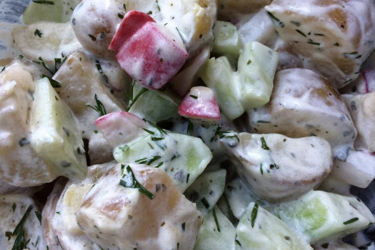 Detail of German potato salad with sour cream and dill dressing.