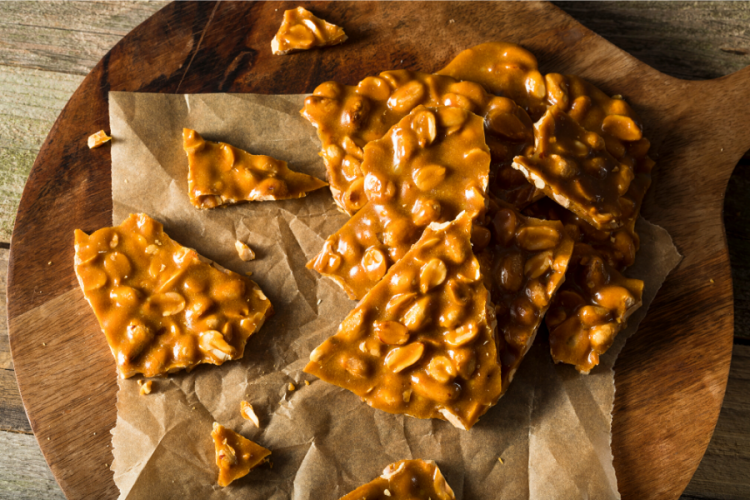 Peanut brittle pieces on a plate.
