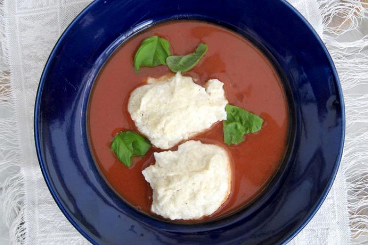 German tomato soup in a plate, decorated with sour cream.