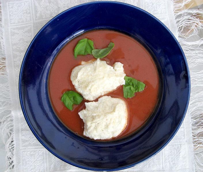German tomato soup in a plate, decorated with sour cream.