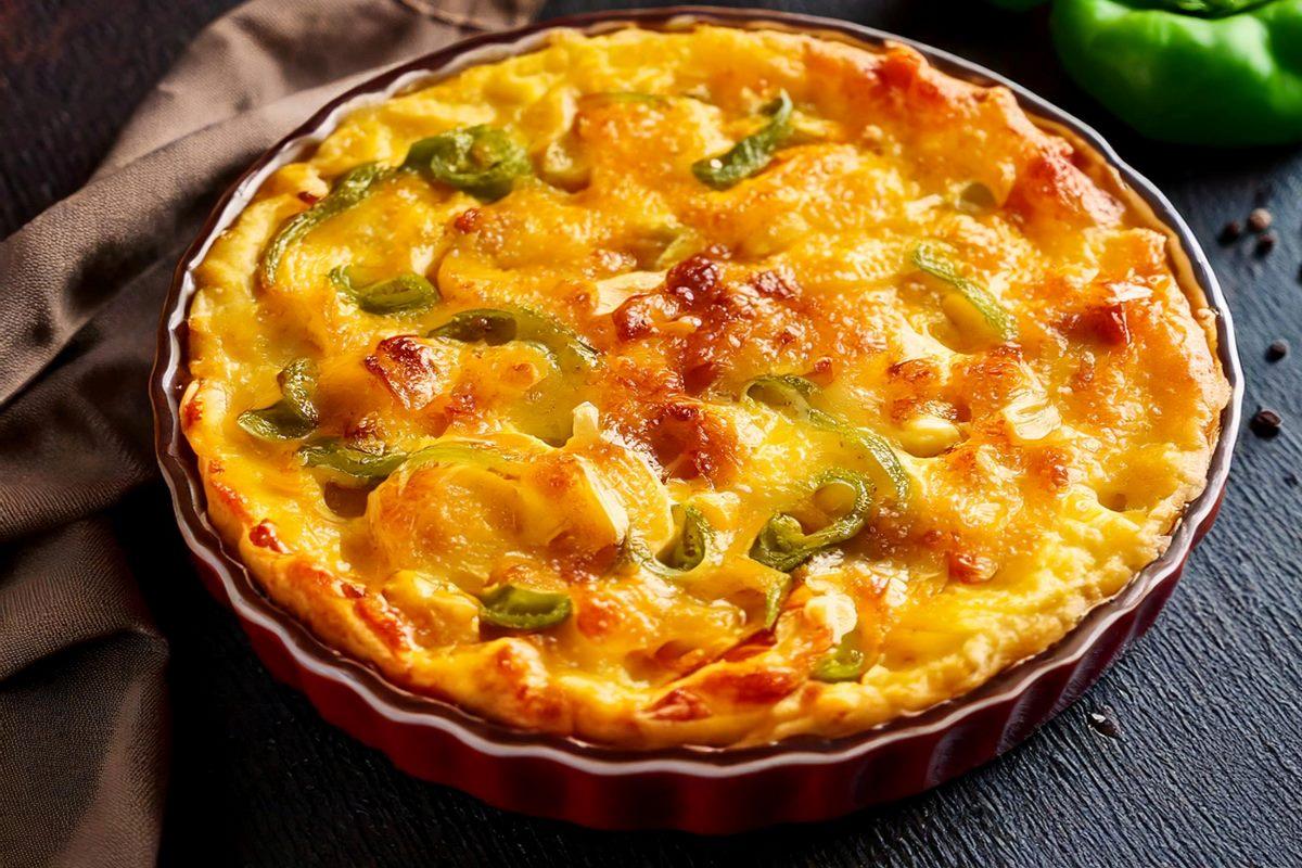 A baking dish with macaroni cheese pie with bell pepper and onion, Bahamian style- AI generated.