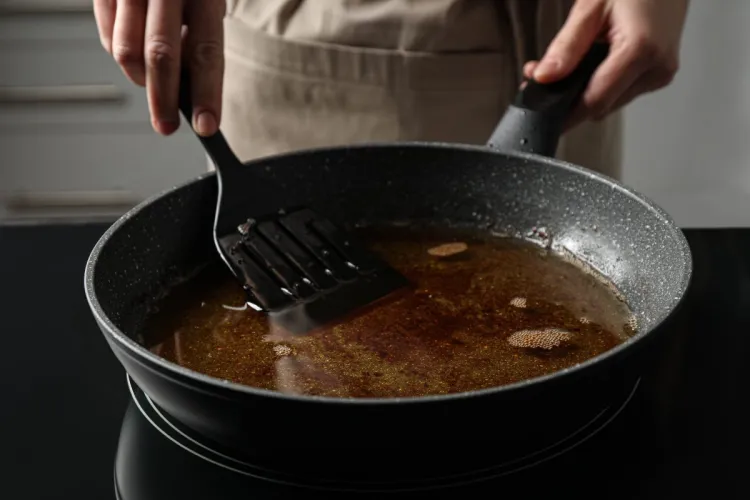 Chef cooking with used cooking oil.
