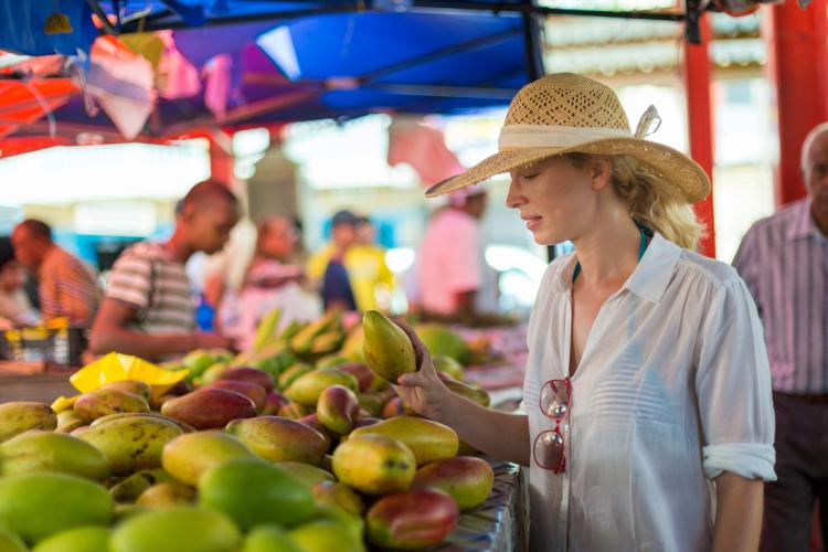 A tourist in a traditional food market in Seychelles.