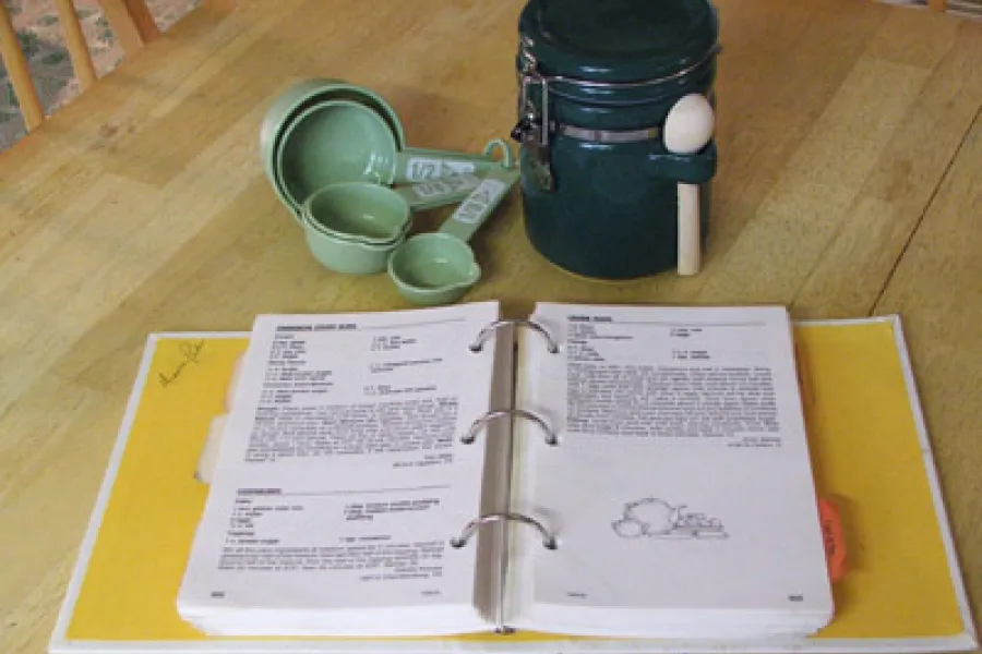 Recipe book and measuring spoons.