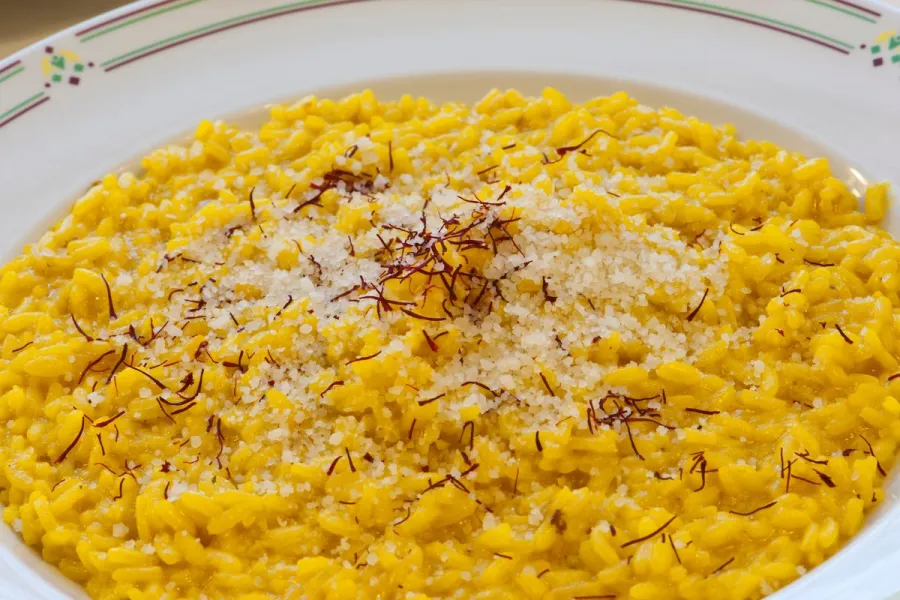 Risotto alla Milanese topped with grated cheese and saffron threads