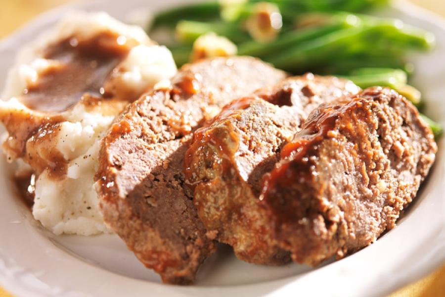 A piece of meatloaf and some meatloaf slices.
