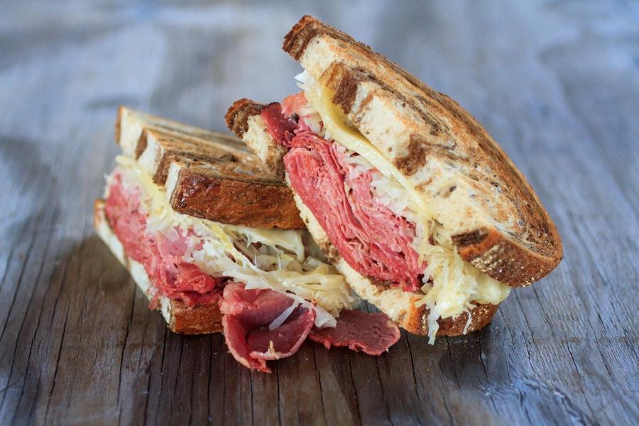 A Reuben sandwich halved.