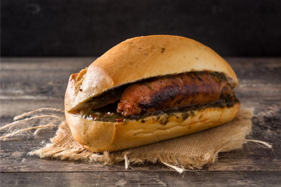 Choripan, a sandwich with grille chorizo sausage, with chimichurri.